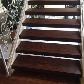 Open, floating oak staircase and flooring with rosewood stain