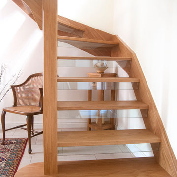 Open tread oak staircase with glass down stands