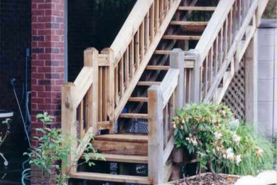 Staircase - mid-sized traditional wooden straight open staircase idea in Atlanta
