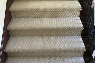 Inspiration for a mid-sized timeless carpeted straight staircase remodel in Orange County with wooden risers
