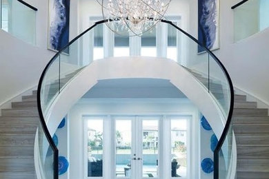 Staircase - large contemporary tile u-shaped glass railing staircase idea in Miami with tile risers