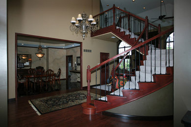 Staircase - huge contemporary carpeted curved staircase idea in Wichita with metal risers