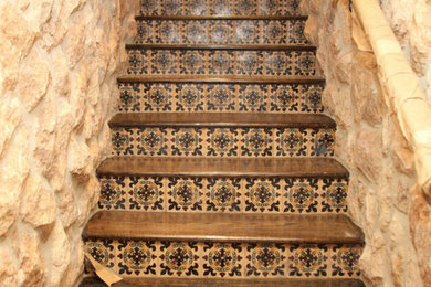 Staircase - large mediterranean wooden straight mixed material railing staircase idea in Los Angeles with tile risers