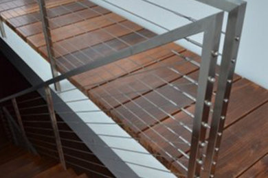 Example of a mid-sized minimalist wooden straight metal railing staircase design in Los Angeles with wooden risers