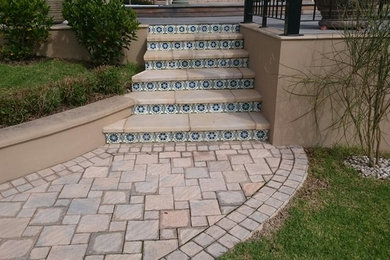 Staircase - traditional staircase idea in Orange County with tile risers