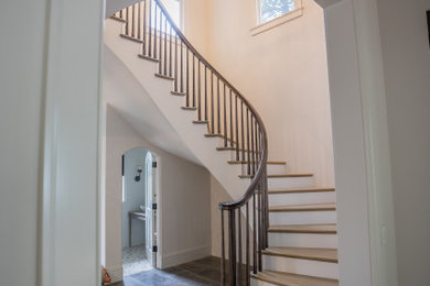 Inspiration for a large timeless wooden curved wood railing staircase remodel in Denver with painted risers