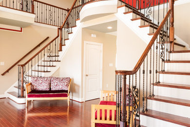 Large wooden mixed material railing staircase photo in Richmond with painted risers