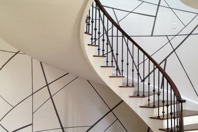 Example of a mid-sized trendy wooden curved staircase design in New York with painted risers