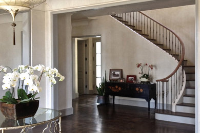 Inspiration for a large timeless wooden curved staircase remodel in San Francisco with wooden risers