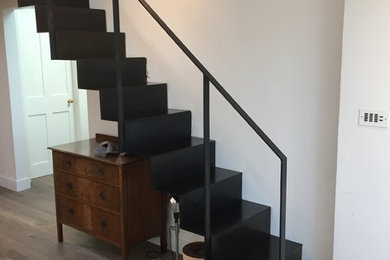 Staircase - small modern metal straight metal railing staircase idea in London with metal risers