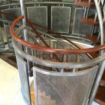 Perforated metal railing with wood handrail
