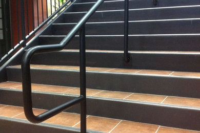 ニューオリンズにある低価格の広いコンテンポラリースタイルのおしゃれな直階段 (金属の蹴込み板) の写真