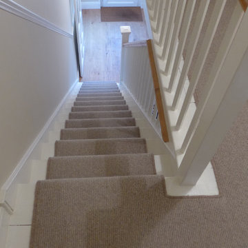 plain stair carpet runner leading to engineered oak hall