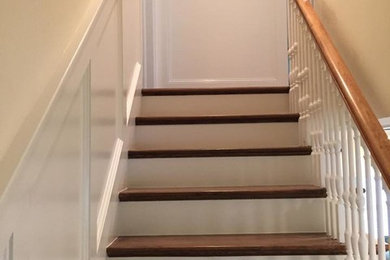 Example of a mid-sized wooden straight staircase design in Denver with painted risers