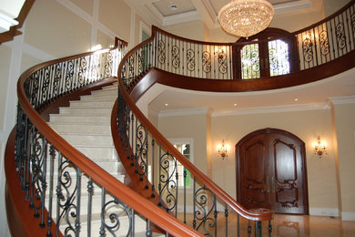 This is an example of an expansive mediterranean curved staircase in Boston.