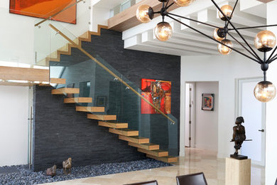 Example of a trendy wooden floating staircase design in Miami