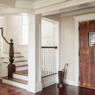 Example of a beach style wooden staircase design in Portland Maine with painted risers