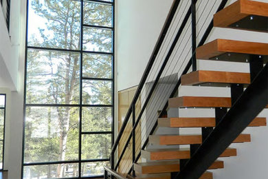 Inspiration for a contemporary wooden straight cable railing and open staircase remodel in Denver