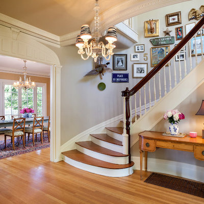 Example of a classic wooden curved staircase design in Portland