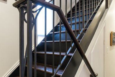 Example of a small classic wooden u-shaped staircase design in Baltimore with metal risers