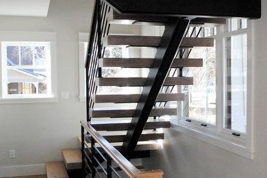 Inspiration for a craftsman wooden floating open staircase remodel in Albuquerque