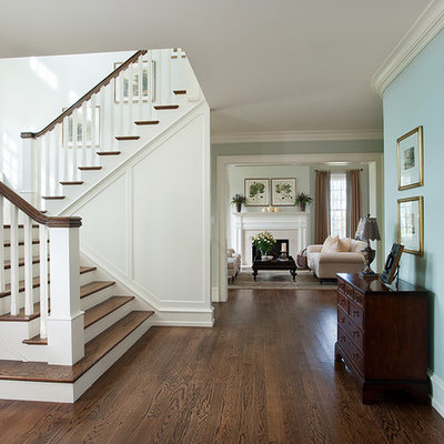 Example of a classic wooden u-shaped wood railing staircase design in Philadelphia with painted risers