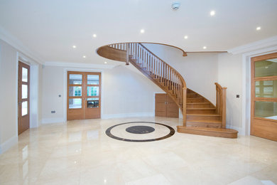 Inspiration for a large classic wood curved staircase in Other with wood risers.