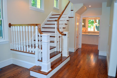 Example of a large classic wooden u-shaped staircase design in Boston with wooden risers