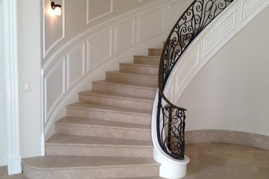 1960s carpeted curved metal railing and wainscoting staircase photo in Orange County with carpeted risers