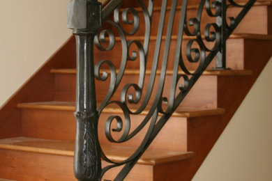 Diseño de escalera recta rústica de tamaño medio con escalones de madera, contrahuellas de madera y barandilla de metal