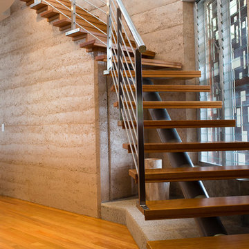 Rammed Earth.  Steel & Timber Staircase.  Custom Staircase