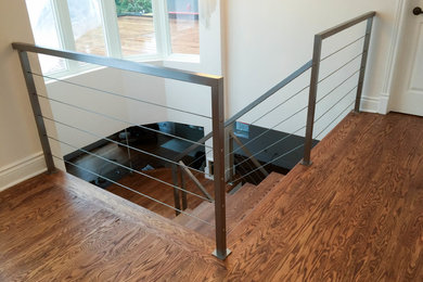 Inspiration for a large industrial metal l-shaped staircase remodel in Montreal with metal risers