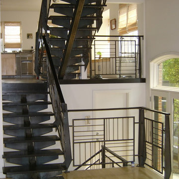 Raw steel railings and single stringer staircase