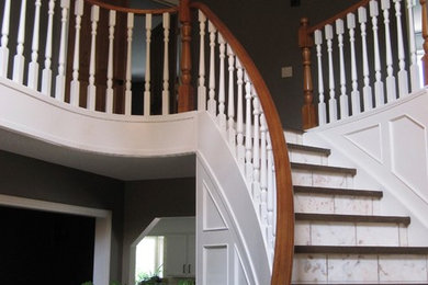 Staircase - large transitional tile curved staircase idea in Calgary with tile risers