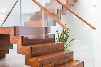 Photo of a contemporary wood l-shaped staircase in Other with wood risers.