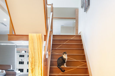 Large trendy wooden u-shaped wood railing staircase photo in Detroit with wooden risers