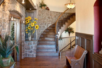 Inspiration for a mid-sized rustic wooden curved staircase remodel in Denver with wooden risers
