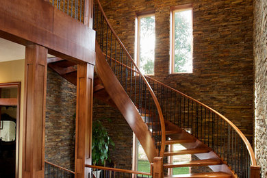 Foto de escalera curva clásica grande sin contrahuella con escalones de madera