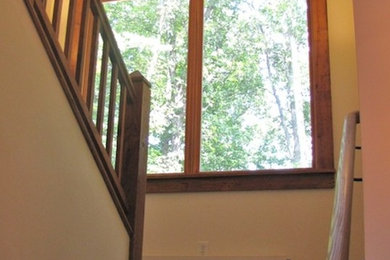 Photo of a traditional wood l-shaped staircase in Other with wood risers.