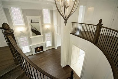 Inspiration for a large transitional wooden curved staircase remodel in Toronto with wooden risers