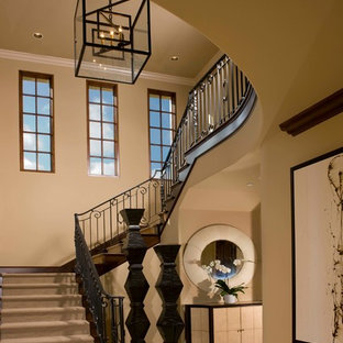 Staircase - large mediterranean carpeted u-shaped metal railing staircase idea in San Diego with carpeted risers