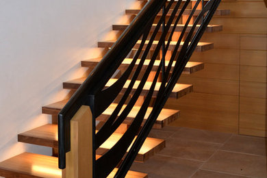 Example of a mid-sized trendy wooden u-shaped open staircase design in Denver