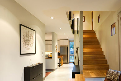 Example of a mid-sized trendy wooden straight staircase design in Other with wooden risers