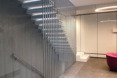Design ideas for a small contemporary floating metal railing staircase in Toronto with marble treads and open risers.