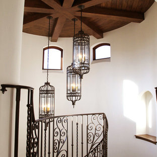 Rustic Beams with Wrought Iron Stairwell