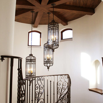 Rustic Beams with Wrought Iron Stairwell