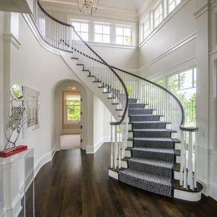 Example of a transitional wooden curved wood railing staircase design in Chicago with wooden risers