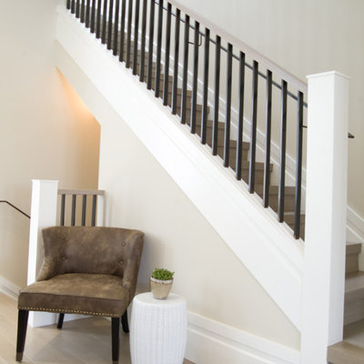 Transitional wooden staircase photo in Omaha with wooden risers
