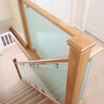 Sandblasted glass clamped into oak staircase renovation