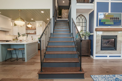Large transitional wooden straight metal railing staircase photo in Atlanta with painted risers